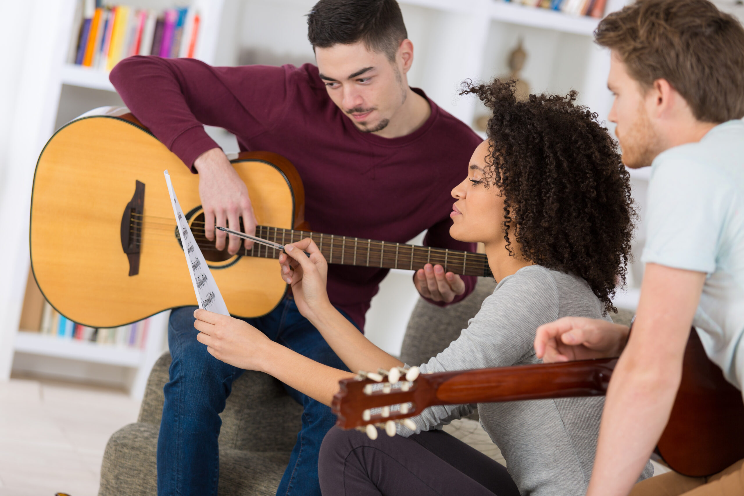 Young people playing music, songwriting